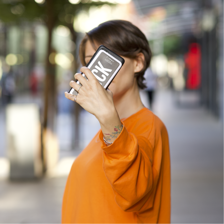 A woman holding up a Brick power bank